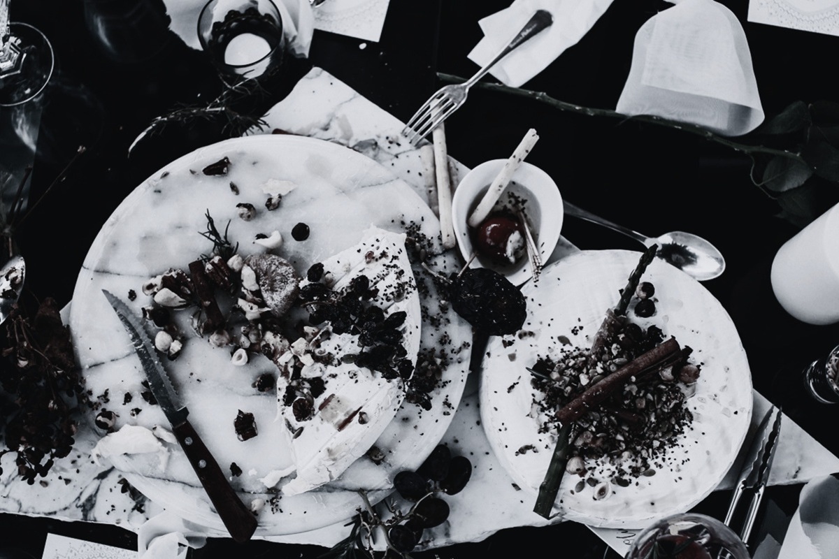 Leftover food on marble plates after hotel dining service, illustrating food waste in hospitality F&B operations