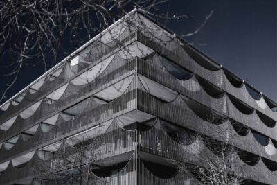 Modern hotel facade with mixed glass and wood panel cladding, illustrating how building design shapes a hotel's sustainability performance