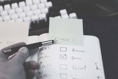 Checklist marked "Done" next to a keyboard, symbolising the misconception that hotel sustainability certification is the end of the work