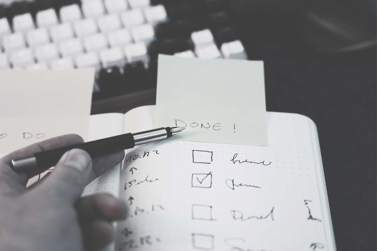 Checklist marked "Done" next to a keyboard, symbolising the misconception that hotel sustainability certification is the end of the work